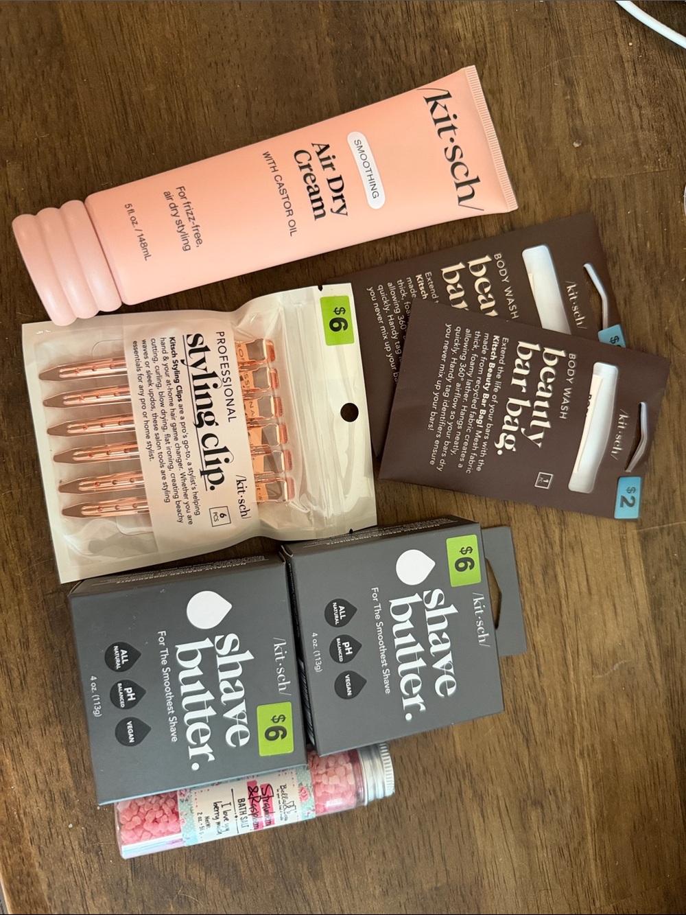 Kitsch pink Air Dry Cream with rose gold clips and gray shave butter boxes